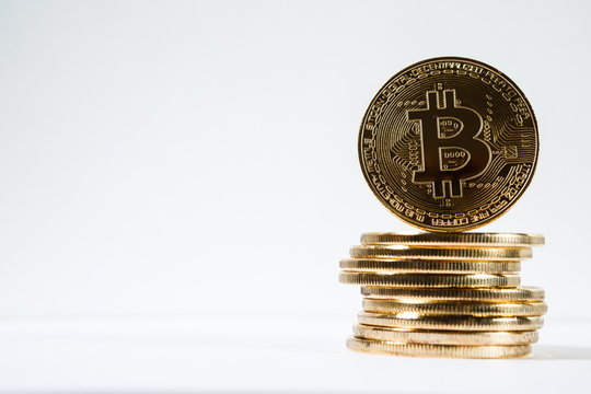 New virtual money Golden bitcoin coin on a white. Cryptocurrency. Business and Trading concept.