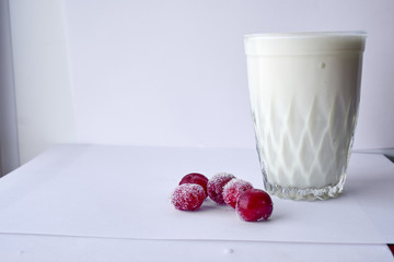 bun and faceted glass of yogurt