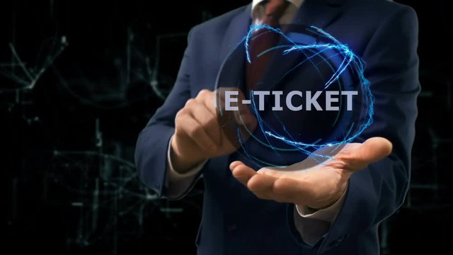 Businessman shows concept hologram E-ticket on his hand. Man in business suit with future technology screen and modern cosmic background