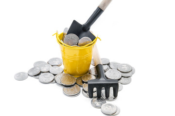 A full bucket of money and a shovel. The concept of monetary abundance