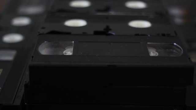 Put and take a vhs tape from a stack of tapes
