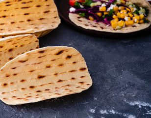 Vegetarian taco wraps. Vegetable tacos with ingredients on rustic surface. Top view, blank space.