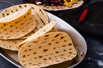 Vegetarian taco wraps. Vegetable tacos with ingredients on rustic surface. Top view, blank space.