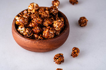 Sweet golden caramel flavoured popcorn in a a glass.