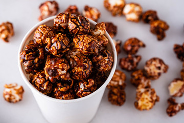 Sweet golden caramel flavoured popcorn in a a glass.