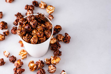 Sweet golden caramel flavoured popcorn in a a glass.