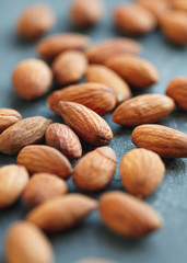 Macro photography of almond nuts over grey background. The concept of healthy and organic food.