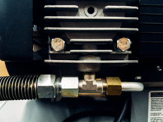 Air compressor system: manometer, cable, gun and accessories, closeup.