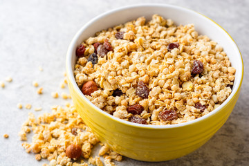Granola and muesli in bowl on gray stone background