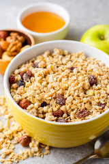 Granola and muesli in bowl on gray stone background