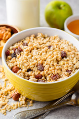 Granola and muesli in bowl on gray stone background