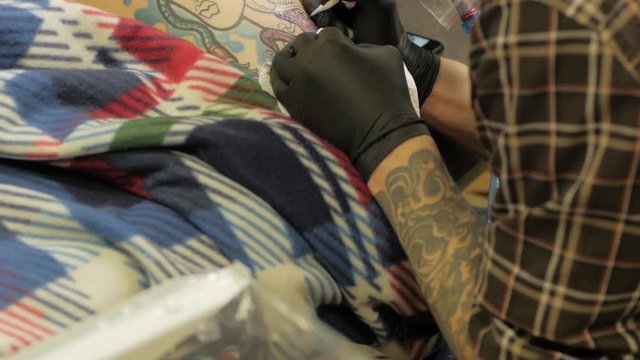 Tattooer at work in studio 