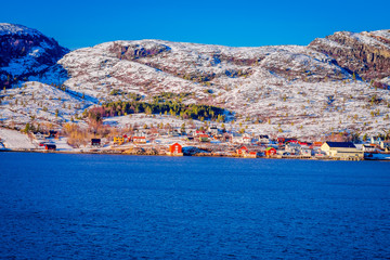 Winter views of wooden houses a long in the coast from Hurtigruten voyage, Northern Norway