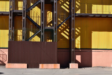 industrial architecture black metal staircase, shadow, yellow building
