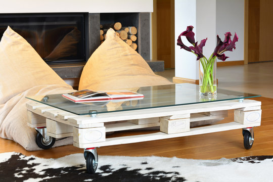 bean bags and pallet coffee table in modern living room - Powered by Adobe