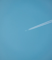 Blue Sky Airplane with Trail