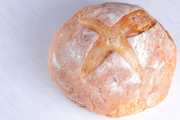 Bread baked in wood stove, white bread on white background, golden crust, bread bakery for designer, agriculture, wheat flour, white wooden background, food, French cuisine