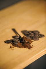 An old silver spoon with ground coffee and chocolate.