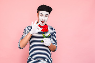Romantic man tear off petals in red rose