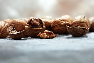 Walnut kernels and whole walnuts on rustic old table