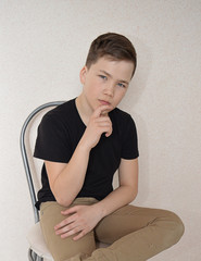 Fototapeta premium the teenager, the young man pensive sitting in the room