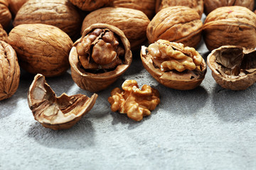 Walnut kernels and whole walnuts on rustic old table