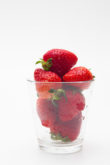 Strawberries in a glass on white bakcground 