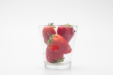 Strawberries in a glass on white bakcground 