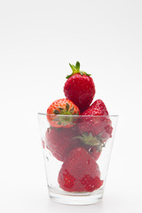 Strawberries in a glass on white bakcground 