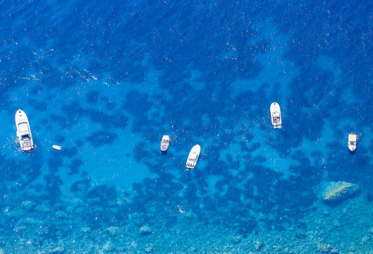 Blue sea and leisure boats seen from the top of Monte Solaro on Capri island, Italy