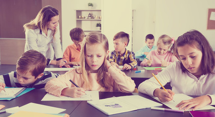 Little children with teacher in classroom