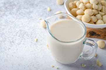 Macadamia milk on a light stone table