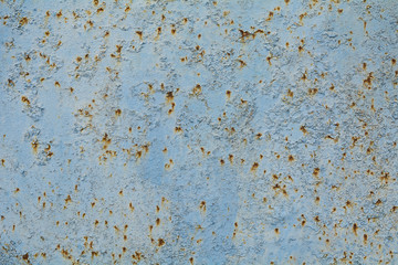 Old rusting metal plate painted in light blue