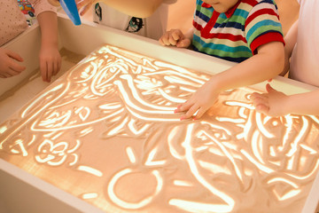 Children paint in the sand, sand animation