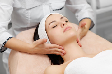 Fototapeta na wymiar Attractive woman enjoying moisturizing procedures in beauty salon.