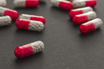 Colorful pills over dark background