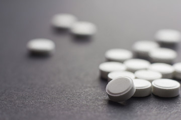 Colorful pills over dark background