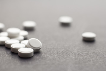 Colorful pills over dark background