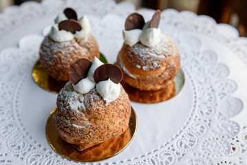 Look from above at delicious baked cakes with cream on top of them