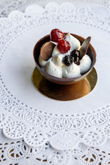 Chocolate bowl with white cream and berries in it
