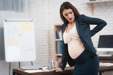 Pretty pregnant girl is experiencing labor in office. Pregnant in office.