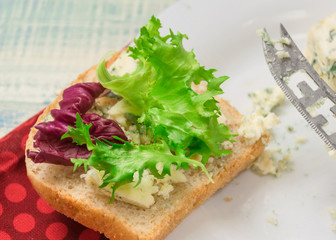 Vegetarian sandwich with salad and blue cheese on a wooden background. Healthy Diet