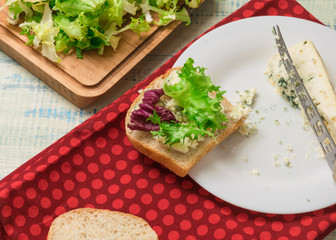 Vegetarian sandwich with salad and blue cheese on a wooden background. Healthy Diet