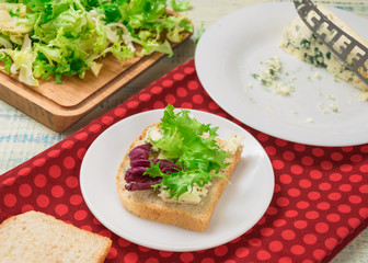 Fototapeta na wymiar Vegetarian sandwich with salad and blue cheese on a wooden background. Healthy Diet