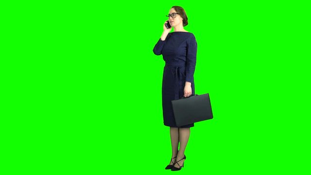 Teacher stand and talking on the phone. Green screen