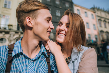 young and beautiful guy and girl sitting on the street
