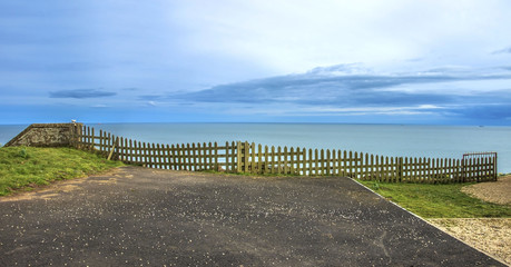 Scotland landscape. Wooden fence on the sea background. St Cyrus, Aberdeenshire, Scotland, UK.