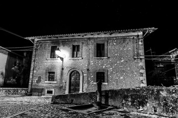 Small town at night with starry sky in Abruzzo, Italy (black and white)