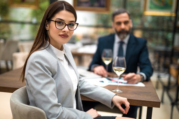 Young businesswoman and man on a business lunch at restaurant.