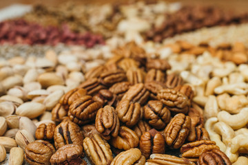 Nuts mix in a canvas bag in table. Ten kinds of nuts: pecan, brazil, cedar, sunflower, hazelnut, almond, peanut walnut pistachio cashew